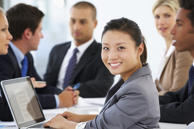 Business meeting with smiling woman facing forward