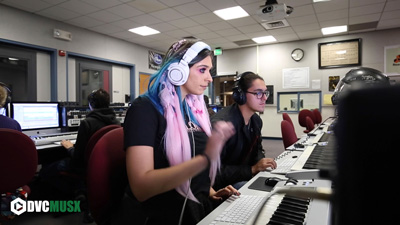 Student composing music on computers
