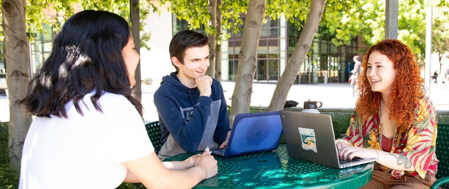 Three students studying outside