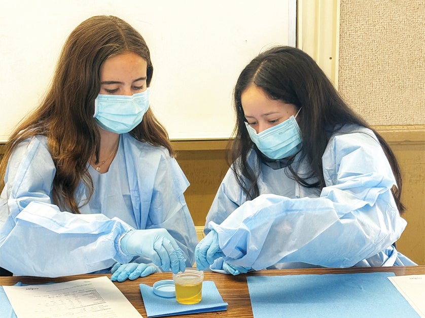 Students performing a lab test in the DVC Health Career Academy