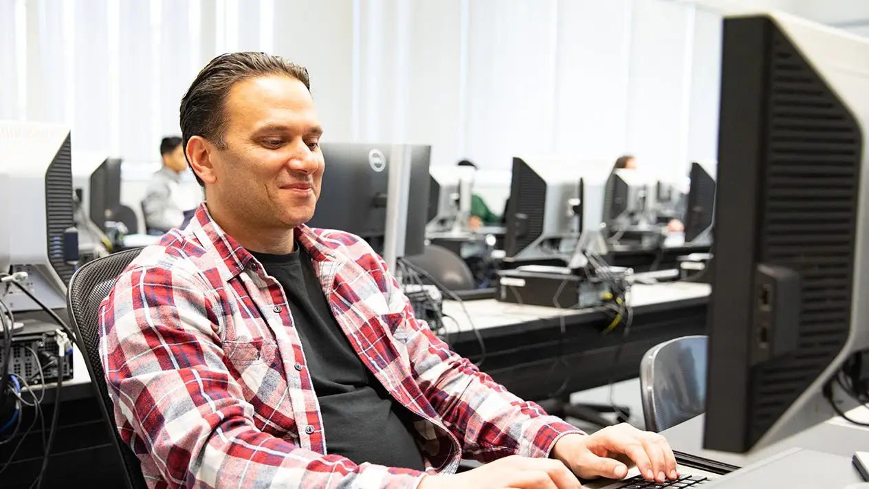 Student typing on a computer