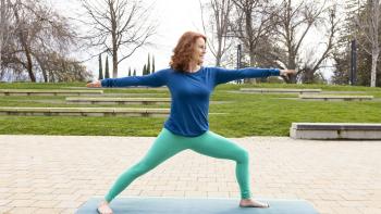 DVC yoga teacher training certificate student Kathy Finley demonstrates a yoga pose