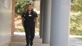 Allied health alumni Alexandra Sooksumphon walking on DVC campus