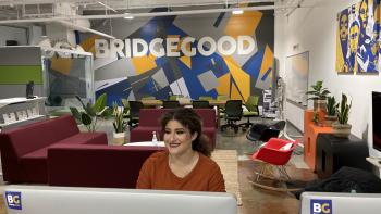 DVC alum Herrara Orellana, sitting at her desk at BRIDGEGOOD