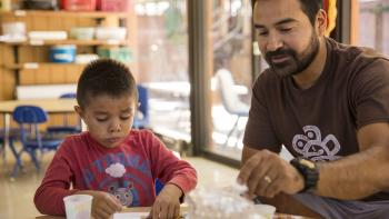 ECE instructor and young child in a classroom