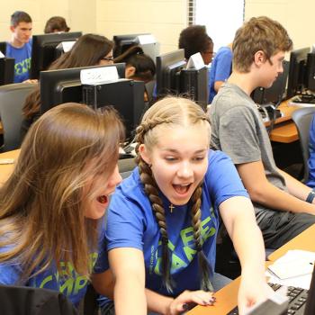 Students engaged in computer learning in a vibrant classroom.