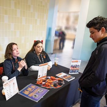A DVC student talking with recruiters.
