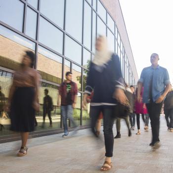 Professional students walking by DVC building