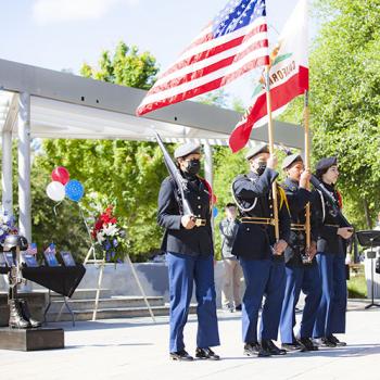 DVC Memorial Day commemoration with soldiers holding USA and CA flags