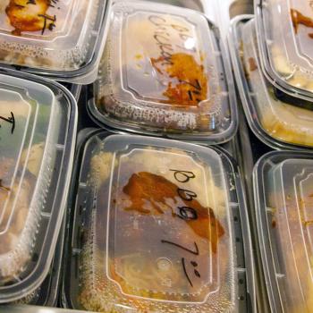 Stack of food containers filled with food