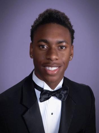 Smiling DVC student Kaden Maultsby wearing a tuxedo and bow tie in a formal portrait.