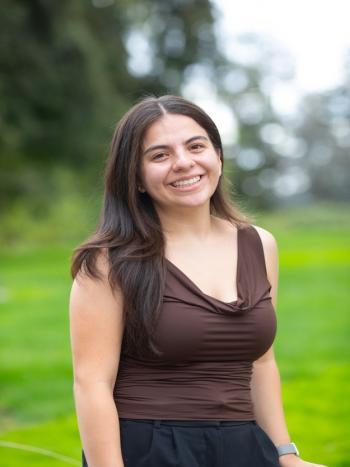 Smiling DVC student Allyson Chombo standing outdoors on campus.