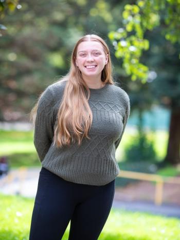 Smiling DVC student Kaitlyn Cooper standing outdoors on campus