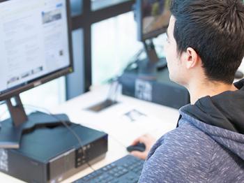 A DVC students works on a computer.