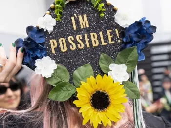 DVC graduate with "I'm Possible" on her mortar board.